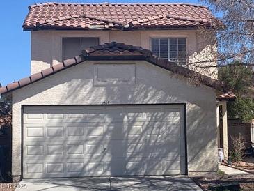 Two-story home featuring a two-car garage and a tile roof, offering great curb appeal at 1016 Vantage Point Rd, Las Vegas, NV 89128
