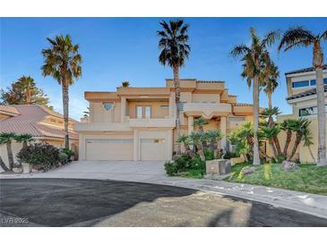 Stunning two-story home boasting lush landscaping and a spacious three-car garage in a luxury community at 2705 Crystal Beach Dr, Las Vegas, NV 89128
