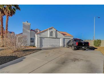 Charming single-story home featuring a three-car garage and well-maintained front yard at 2914 Luminous Ct, North Las Vegas, NV 89032