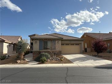 Charming single-story home features desert landscaping, an attached two-car garage, and a neutral color scheme at 3609 Citrus Heights Ave, North Las Vegas, NV 89081