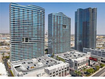 Three striking modern high-rise buildings against a blue sky, showcasing unique architectural design and urban living at 4575 Dean Martin Dr # 1811, Las Vegas, NV 89103