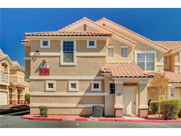 Inviting condo exterior featuring a tile roof, manicured landscaping, and prominent building number at 5855 Valley Dr # 2108, North Las Vegas, NV 89031