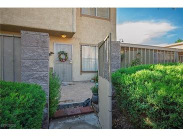 Charming townhome featuring a private gated front entrance and desert landscaping at 6412 Big Pine Way, Las Vegas, NV 89108