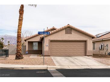 Charming single-story home featuring low maintenance desert landscaping and a two-car garage at 652 Carlos Julio Ave, North Las Vegas, NV 89031