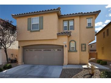 Inviting two-story home featuring a neutral color scheme, arched garage door, and well-maintained landscaping at 7731 Ornamento Way, Las Vegas, NV 89179