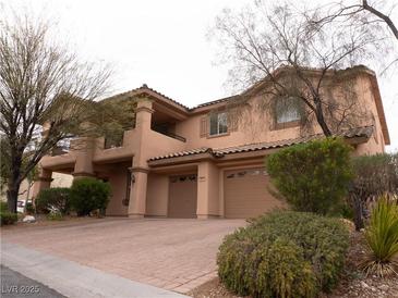 Charming two-story home featuring a three-car garage and landscaped front yard at 8070 Pavarotti Ave, Las Vegas, NV 89178