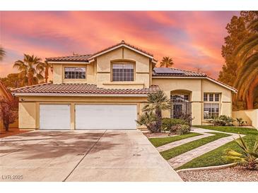 Charming two-story home featuring a tile roof, desert landscaping, and an attached two-car garage at 8324 Slate Harbor Cir, Las Vegas, NV 89128