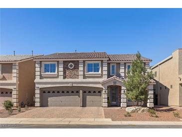 Charming two-story home with a three car garage and stone facade detailing at 9853 Russian Hill St, Las Vegas, NV 89141