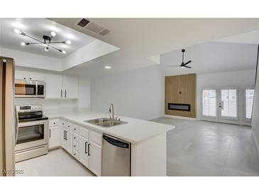Bright, modern kitchen featuring stainless steel appliances and white countertops at 2716 Ferrin Rd, Las Vegas, NV 89117