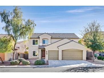 Inviting two-story home boasts a two-car garage and a well-maintained front yard with mature trees at 33 Gentilly Lace Ave, Henderson, NV 89002