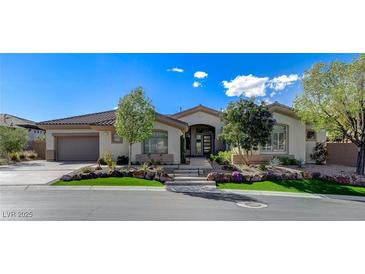 Charming single-story home with lush landscaping, stone accents, and a well-manicured lawn at 33 Hassayampa Trl, Henderson, NV 89052