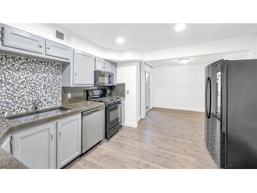 Well-lit kitchen featuring modern stainless steel appliances and sleek countertops at 3944 Visby Ln, Las Vegas, NV 89119