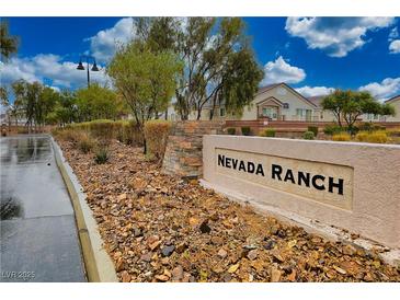 Nevada Ranch community entrance sign with lush landscaping and well-maintained surroundings on a partly cloudy day at 4850 Straight Flush Dr # 103, Las Vegas, NV 89122
