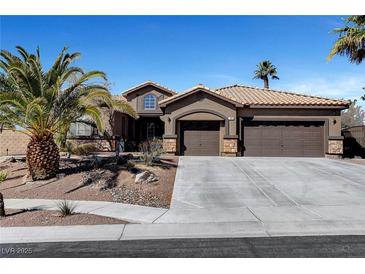 Beautiful single-story home featuring a desert landscape, tile roof, and a spacious three-car garage at 563 Moon Chase St, Las Vegas, NV 89110