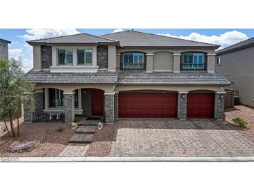 Stunning two-story home with a three-car garage, stone accents, and a meticulously maintained front yard at 7255 Bold Rock Ave, Las Vegas, NV 89113