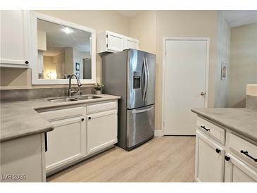 Bright kitchen features stainless steel appliances, light wood floors, and white cabinets at 9000 S Las Vegas Blvd # 1187, Las Vegas, NV 89123