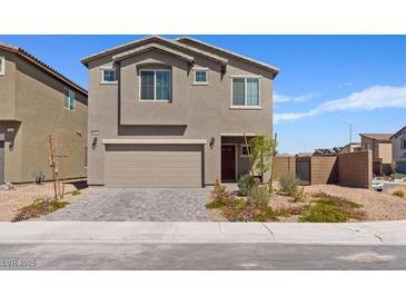 Charming two-story home with a well-manicured front yard and an attached two-car garage in a suburban neighborhood at 1876 Jamie Brook Pl, North Las Vegas, NV 89084
