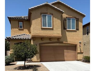 Two-story home with tan stucco, brown trim, and a two-car garage at 3104 Naggio Shores Ave, Las Vegas, NV 89141