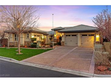 Beautiful single-story home with a well-manicured lawn, desert landscaping, and a spacious driveway leading to a two-car garage at 6907 May Basket Ave, Las Vegas, NV 89131