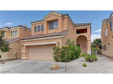 Two-story home with a tan stucco exterior, tile roof, and two-car garage at 8980 High Horizon Ave, Las Vegas, NV 89149