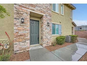 Inviting townhome featuring a stone facade and a well-manicured lawn at 965 Nevada State Dr # 8202, Henderson, NV 89002