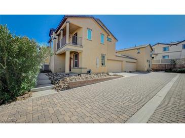Charming home with a two-story exterior, balcony and a paved driveway on a sunny day at 971 Sable Chase Pl, Henderson, NV 89011