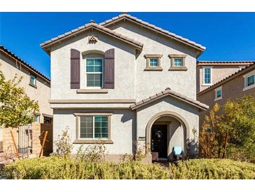 Charming two-story home featuring neutral stucco, arched entry, shutters, and a well-maintained front yard at 10604 Sariah Skye Ave, Las Vegas, NV 89166