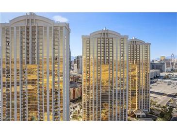 Striking exterior view of golden glass condo towers with beautiful architecture against a bright blue sky at 145 E Harmon Ave # 2021, Las Vegas, NV 89109