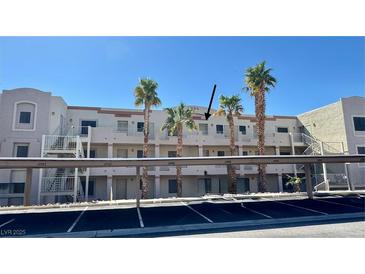 Exterior view of the property showing the building and palm trees in front at 2064 Mesquite Ln # 303, Laughlin, NV 89029