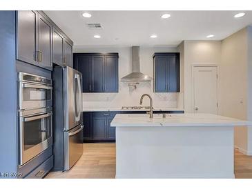 Modern kitchen features stainless steel appliances and a spacious island at 31 Castleton Tower Ct, Henderson, NV 89011