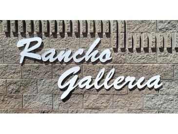 Rancho Galleria sign on a textured brick wall, in bright white lettering, clearly visible at 327 Perry Ellis Dr, Henderson, NV 89014