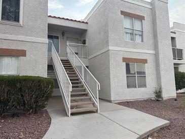 Two-story condo featuring stairs to the unit with desert landscaping at 6800 E Lake Mead Blvd # 1018, Las Vegas, NV 89156