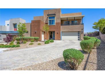 Contemporary two-story home with a balcony, three-car garage and desert landscaping at 7222 Pulsar Mesa Ct, Las Vegas, NV 89148