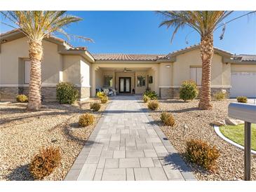 Charming home featuring palm trees and a long walkway leading to the inviting front entrance at 9117 Hickam Ave, Las Vegas, NV 89129