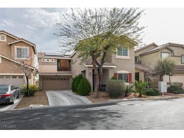 Charming two-story home with a landscaped front yard and a two-car garage at 10450 Kepler Cascades St, Las Vegas, NV 89141