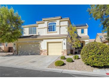 Charming two-story home with a three-car garage and well-maintained landscaping at 5824 Farmhouse Ct, Las Vegas, NV 89141