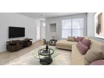 Bright living room with beige sofa, large window, and stylish glass coffee table at 5855 Valley Dr # 2020, North Las Vegas, NV 89031