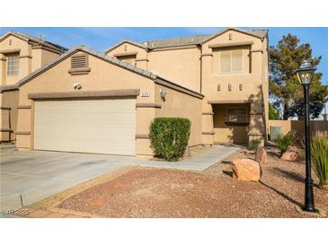 Charming two-story home featuring an attached two-car garage and well maintained landscaping at 6120 Crystal Cascade St, Las Vegas, NV 89130
