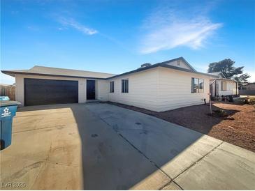 Charming single-story home featuring a two-car garage and a well-maintained front yard with desert landscaping at 6479 Gunderson Blvd, Las Vegas, NV 89103