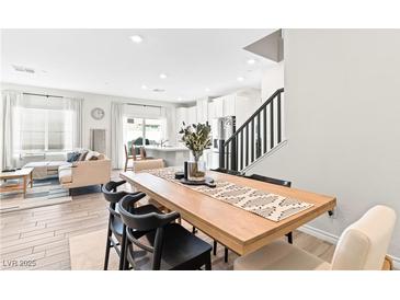 Open-concept dining room with hardwood floors and adjacent living room, perfect for entertaining at 7350 N Decatur Blvd # 5, Las Vegas, NV 89131