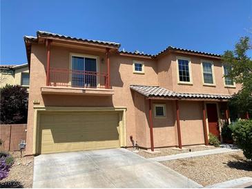 Charming two-story home featuring a balcony, covered entry, and a two-car garage with desert landscaping at 8122 Retriever Ave, Las Vegas, NV 89147