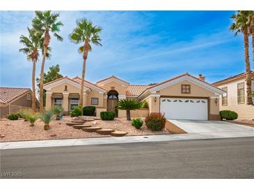 Beautiful one-story home with desert landscaping, concrete steps and tall palm trees under a bright blue sky at 10421 Shoalhaven Dr, Las Vegas, NV 89134