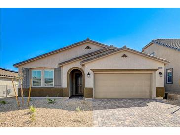 Charming single-story home features desert landscaping, neutral stucco, an arched entryway, and a two-car garage at 10981 Cilantro Ave, Las Vegas, NV 89166