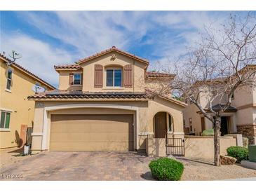 Charming two-story home features a well-kept front yard and a two-car garage at 1422 Ozzie Smith Ave, Henderson, NV 89074