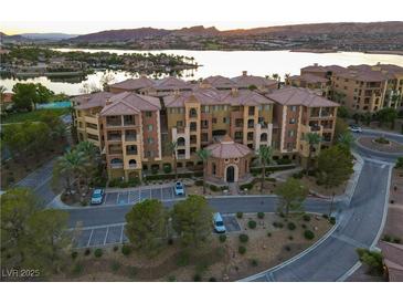 Beautiful condo building with manicured landscaping and ample parking spaces at 15 Via Mantova # 104, Henderson, NV 89011