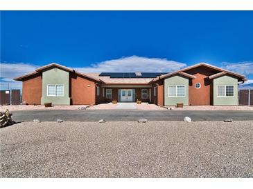 Charming single-story home with xeriscaping, solar panels, and unique architectural style at 2330 Deadwood St, Pahrump, NV 89048