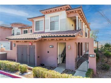 Charming two-story home featuring a stucco exterior, tile roof, and well-maintained landscaping at 26 Via Vasari # 204, Henderson, NV 89011