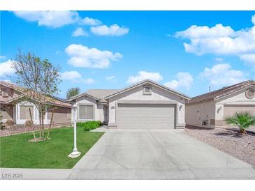 Charming single-story home features a well-maintained lawn, neutral tones, and a two-car garage at 5988 Turtle River Ave, Las Vegas, NV 89156