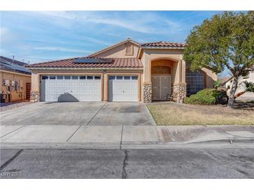 Charming single-story home with a three-car garage and desert landscaping at 1036 Kennebunk Cir, Henderson, NV 89015