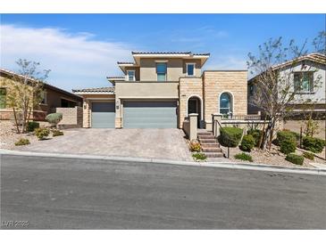 Stunning two-story home featuring a three-car garage, neutral stucco, and stone accents on a beautifully landscaped lot at 11834 Albissola Ave, Las Vegas, NV 89138